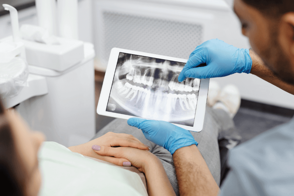 Dentist showing dental plaque to patient