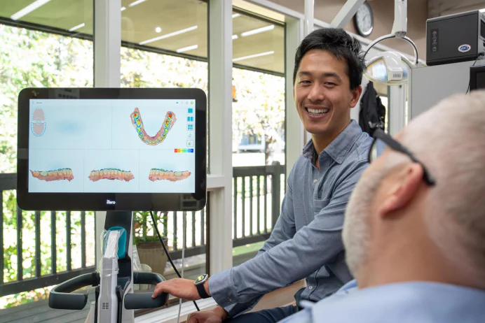 Dr. David Chi of Manson & Chi Dentistry in Kirkland, WA, performing a dental patient consultation